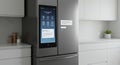 Modern smart refrigerator with touchscreen interface in a minimalist bright kitchen setting Royalty Free Stock Photo