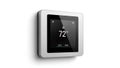 A modern smart thermostat displaying temperature on a sleek screen Royalty Free Stock Photo