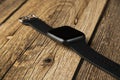 Modern smart watches are multifunctional. Clock on a wooden background Royalty Free Stock Photo