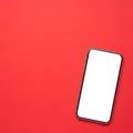 Modern smartphone with a blank white screen on a vibrant red background isolated on white background Royalty Free Stock Photo