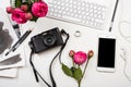 Modern smartphone, computer keyboard, pink flowers and photo cam Royalty Free Stock Photo