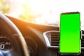 Modern smartphone device gadget mounted on phone holder at car dashboard. Mock-up green chroma key screen isolated template. Royalty Free Stock Photo