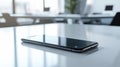 Modern Smartphone Lying Flat on Sleek White Desk with Glowing Screen in Bright Office Setting. Concept of Technology Royalty Free Stock Photo