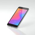 A modern smartphone with a metallic frame and black front lies on a reflective surface.