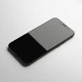 A modern smartphone with a sleek black design is placed on a white Royalty Free Stock Photo