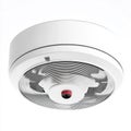 Modern smoke detector with red alert sensor for fire safety installed on white ceiling Royalty Free Stock Photo