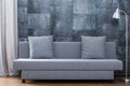 Modern sofa and concrete wallpaper Royalty Free Stock Photo