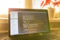 Modern software development background: nice looking laptop with programm