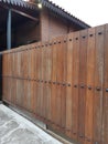 Modern solid wood fence in brown color with iron nails detail