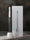 Modern sonic electric toothbrush. Made from gray metal. Nearby storage case, charger and replacement brush head Professional oral Royalty Free Stock Photo