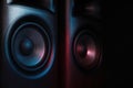 Modern sound speakers in neon light on black background, closeup Royalty Free Stock Photo