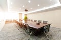 Modern and spacious conference room with two long tables and chairs, perfect for corporate meetings