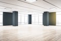 Modern spacious empty hall room with black columns, big windows, light ceiling with led lights and wooden floor Royalty Free Stock Photo