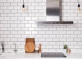 Modern spacious kitchen with white brick tile wall.