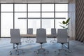 Modern spacious meeting room interior with panoramic window and city view, furniture and decorative plant. Office designs concept Royalty Free Stock Photo