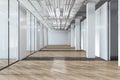 Modern spacious office hallway interior with wooden flooring.