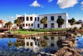 Modern Spanish building and ornamental pond