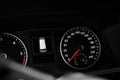 Modern speedometer, tachometer and door warning sign on car dashboard