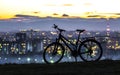 Modern sports city bicycle standing alone over night city background