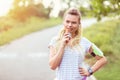 Modern sporty young woman eating energy bar after run in park Royalty Free Stock Photo