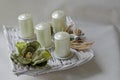 Modern square shaped advent wreath with white candles and nature decoration