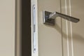 Modern stainless steel door handle on white wooden doors Royalty Free Stock Photo