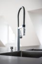 a modern kitchen sink with stainless steel fixtures in a newly renovated house Royalty Free Stock Photo