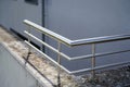 Modern stainless steel railing mounted on a concrete wall Royalty Free Stock Photo