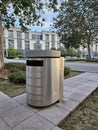 Modern Stainless Steel Trash Bin on a Sidewalk in Urban Area Royalty Free Stock Photo