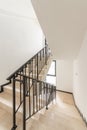 Modern stair case between floors. Stairs with metallic rail in modern building