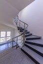 Modern stair case between floors. Stairs with metallic rail in modern building