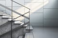 Modern staircase with clean lines and natural light casting shadows. Interior design concept. Royalty Free Stock Photo