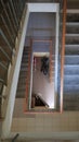 Modern stairwell in a residential building. Staircase in perspective. Gray ceramic tile. Common staircase with a brown wooden Royalty Free Stock Photo