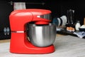 Modern stand mixer on table in kitchen. Space for text