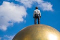 Modern statue man on ball gold