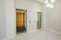 Modern steel elevator cabins in the business lounge or hotel, shop, salon, office, widescreen in perspective. Royalty Free Stock Photo