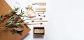 Modern still life scene with olive branch, zero waste products for the home. Bamboo toothbrushes and ear sticks, reusable cotton s