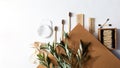 Modern still life scene with olive branch, zero waste products for the home. Bamboo toothbrushes and ear sticks, reusable cotton s