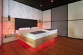 modern stone pine bed with led lighting, hanging lamps Royalty Free Stock Photo