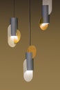 Modern streamlined gold and gray chandelier. Metal brass shade pendant. on brown background. Chandelier in the style of