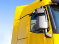 Modern, streamlined truck cab with good aerodynamics with a rearview mirror. Yellow truck cab, background Royalty Free Stock Photo