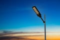 A modern street LED lighting pole. Urban electro-energy technologies. Poles on the road with LED light. Outdoor lighting strong LE Royalty Free Stock Photo