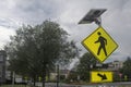 Modern Street sidewalk pole with solar panels  night light Street sign with the symbol with a figure walking crosswalk area bright Royalty Free Stock Photo