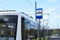 Modern streetcar near tram stop sign outdoors Royalty Free Stock Photo