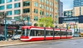 Modern streetcar on a street of Toronto. The Toronto streetcar system is the largest and the busiest light-rail system