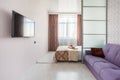 Modern studio apartment design with bedroom and living space. Hotel room, glass sliding door. City flat concept Royalty Free Stock Photo