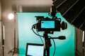 Modern studio with professional video camera and green screen - chromakey. TV camera for recording live show Royalty Free Stock Photo