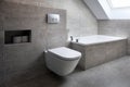 A modern style bathroom with gray tiles.