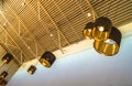 Modern style bronze decorative lamps and Golden lampshades hang on a long rope, industrial ceiling, interior design