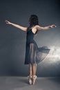 Modern style dancer posing on grey background